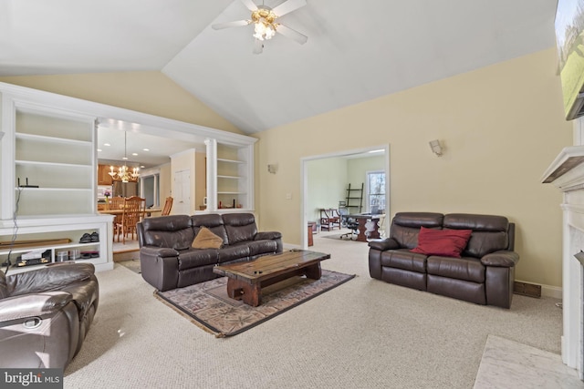 living area with baseboards, lofted ceiling, carpet floors, a premium fireplace, and ceiling fan with notable chandelier