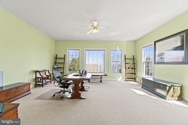 carpeted home office with baseboards, a healthy amount of sunlight, and ceiling fan