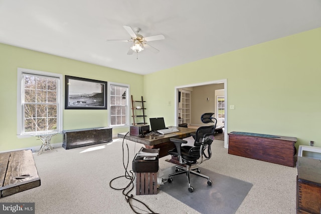 carpeted office featuring a ceiling fan