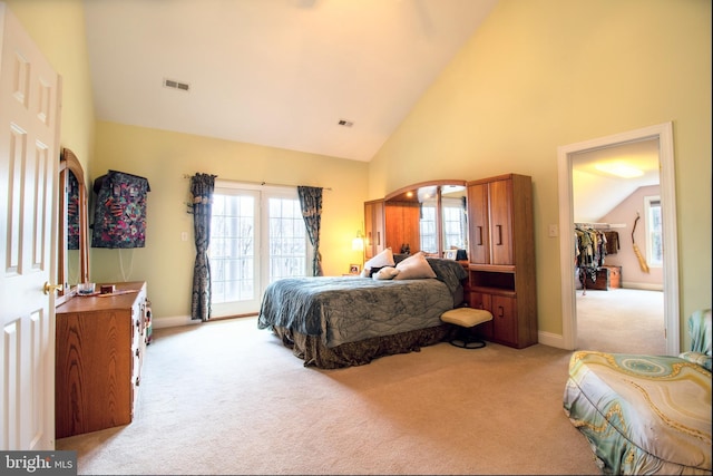 bedroom featuring carpet flooring, arched walkways, visible vents, and high vaulted ceiling