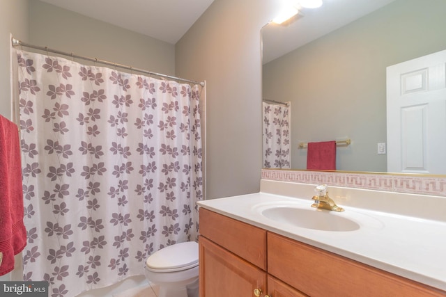 bathroom featuring toilet, vanity, and a shower with curtain