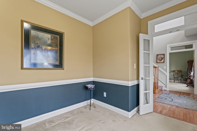 carpeted spare room with baseboards and ornamental molding