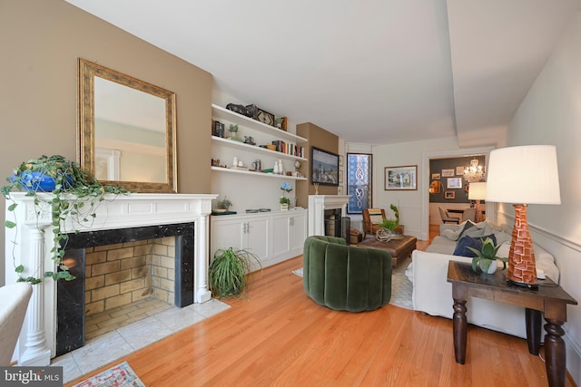 living room featuring light wood finished floors and a premium fireplace