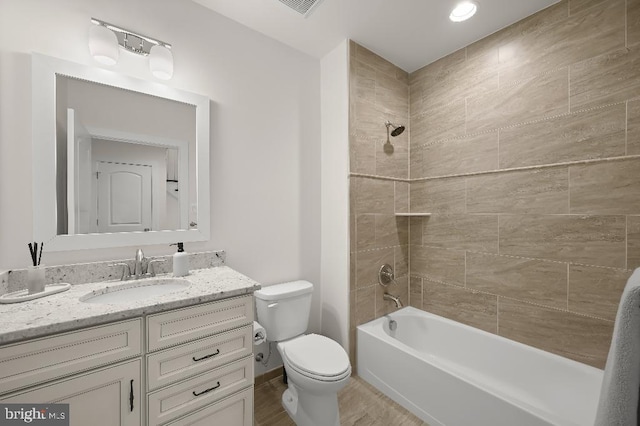 full bath featuring vanity, toilet, and tub / shower combination