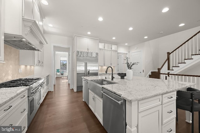 kitchen featuring recessed lighting, white cabinetry, and high end appliances