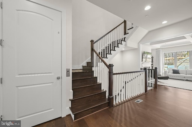 stairway with recessed lighting, wood finished floors, and visible vents