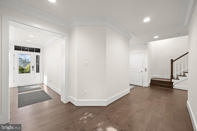 entryway with ornamental molding, wood finished floors, recessed lighting, baseboards, and stairs