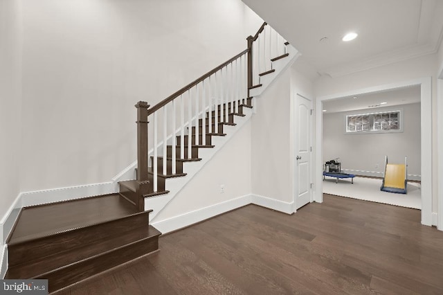 stairs with recessed lighting, baseboards, wood finished floors, and ornamental molding