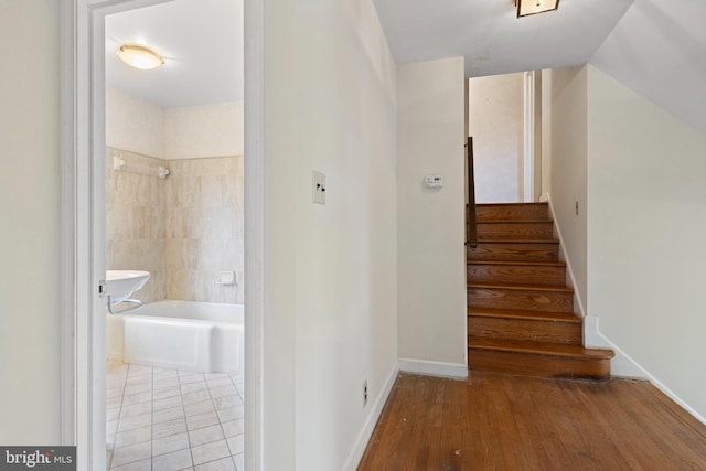 stairway featuring wood finished floors and baseboards