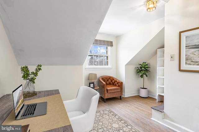 office featuring vaulted ceiling, wood finished floors, and baseboards