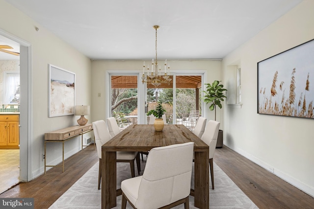 dining room featuring baseboards, an inviting chandelier, and dark wood-style flooring