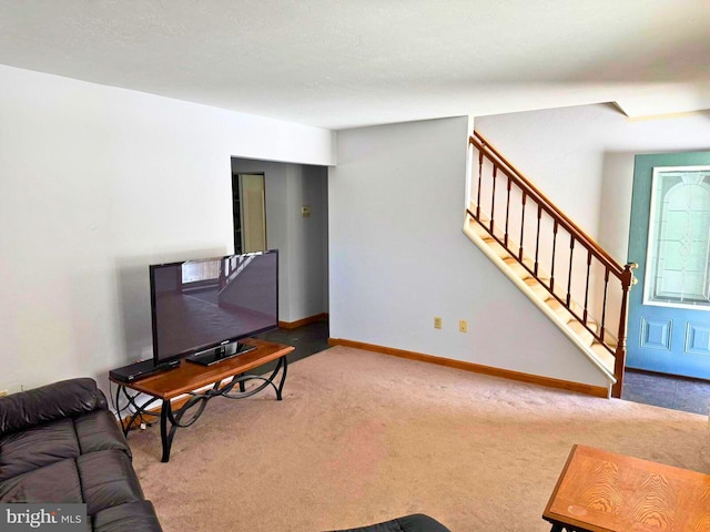 living area with carpet flooring, stairs, and baseboards