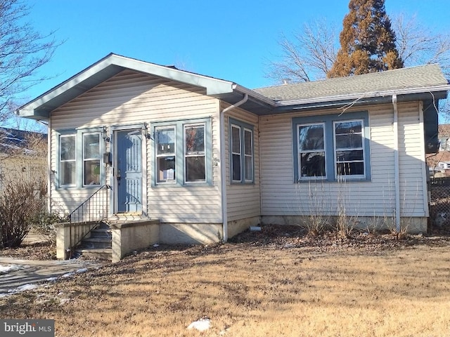 bungalow-style house featuring roof with shingles