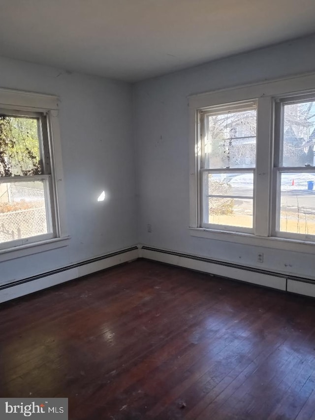 unfurnished room featuring a healthy amount of sunlight and dark wood-type flooring