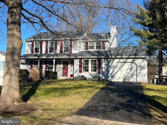 view of front of property featuring driveway, a front lawn, a chimney, and an attached garage