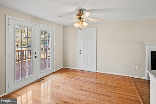 entrance foyer featuring light wood-type flooring, visible vents, a ceiling fan, french doors, and baseboards