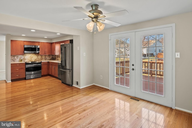 kitchen with visible vents, light countertops, light wood-style flooring, appliances with stainless steel finishes, and french doors