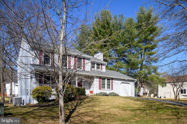 traditional home featuring a front lawn, central AC unit, a garage, and a chimney