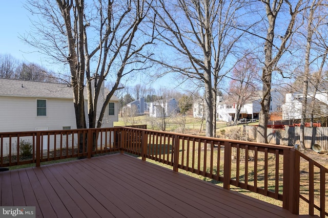 wooden terrace featuring a residential view and fence