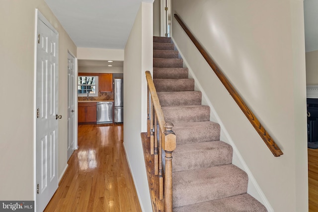 stairway featuring wood finished floors