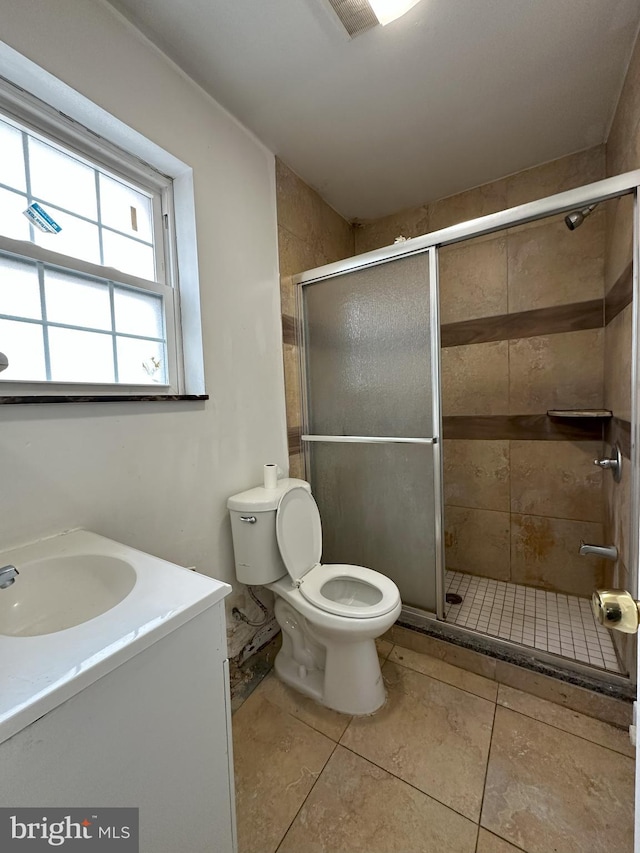 bathroom with vanity, toilet, and a stall shower