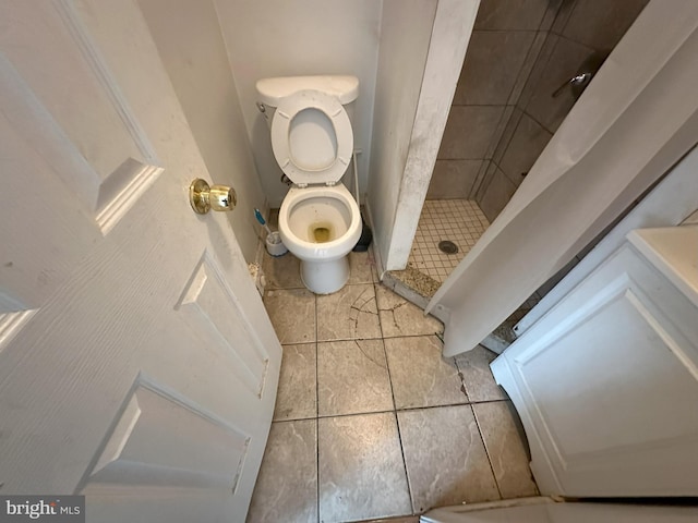 full bathroom featuring tile patterned floors, a shower stall, and toilet