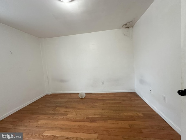 unfurnished room featuring wood finished floors and baseboards