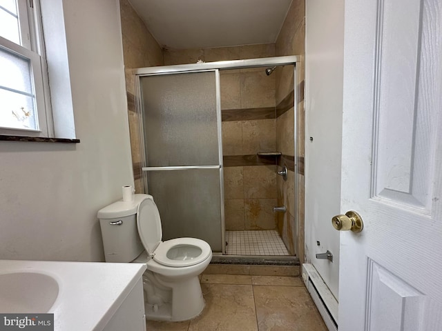 full bathroom with vanity, a shower stall, toilet, and baseboard heating