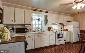 kitchen with white cabinetry, white appliances, a ceiling fan, and brick floor