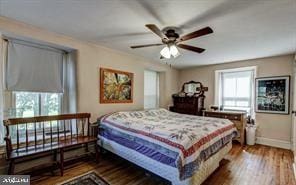 bedroom featuring baseboards and wood finished floors