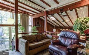 sunroom with lofted ceiling, plenty of natural light, and a ceiling fan