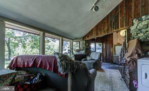 living area with plenty of natural light and lofted ceiling