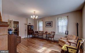 living area featuring a notable chandelier and wood finished floors