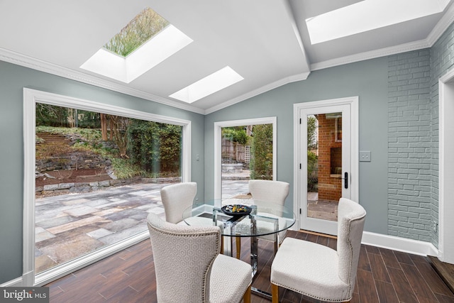 sunroom with vaulted ceiling with skylight