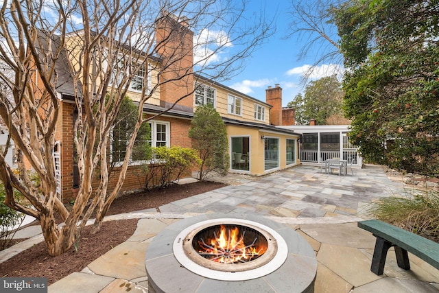 view of patio / terrace featuring a sunroom