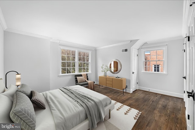 bedroom with dark wood finished floors, crown molding, baseboards, and visible vents