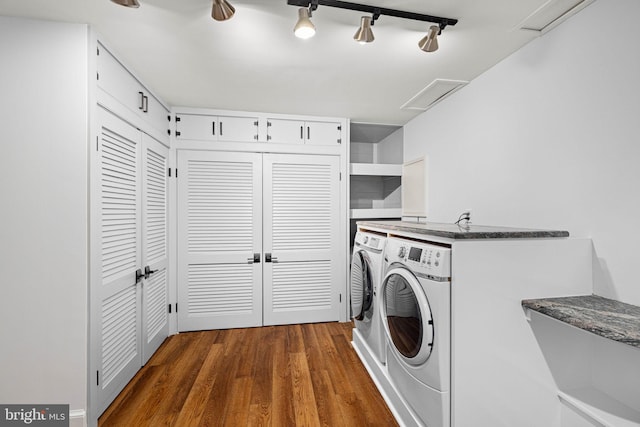 laundry area featuring laundry area, washing machine and dryer, and wood finished floors