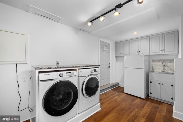 laundry room with dark wood-style flooring, washer and dryer, laundry area, and a sink