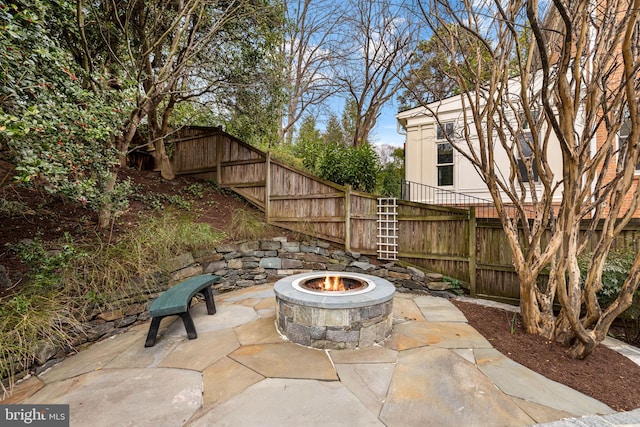 view of patio featuring fence and an outdoor fire pit