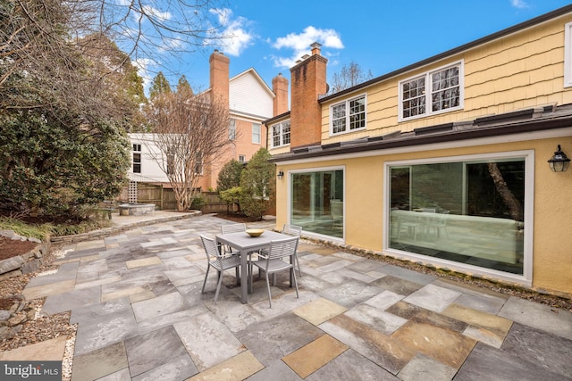 view of patio / terrace with outdoor dining space and fence