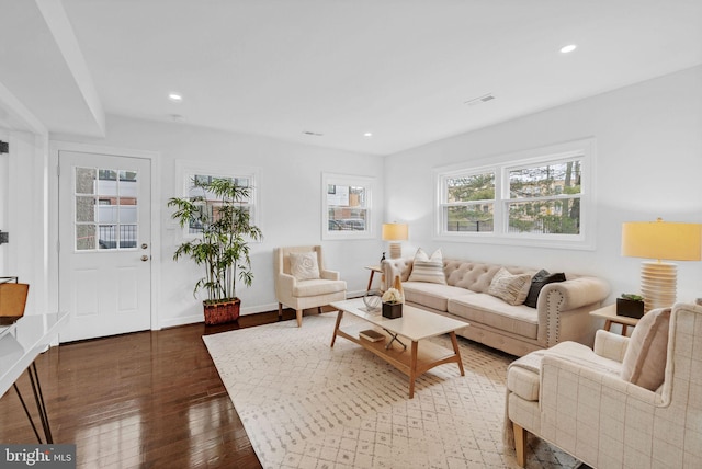 living area with hardwood / wood-style floors, recessed lighting, and baseboards