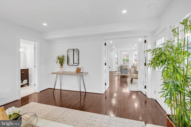 interior space with hardwood / wood-style flooring, recessed lighting, and baseboards