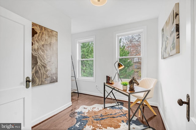 office area with baseboards and wood finished floors