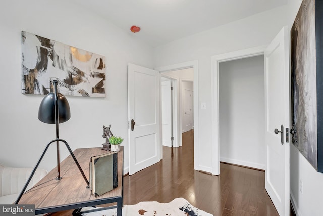 home office featuring wood finished floors and baseboards