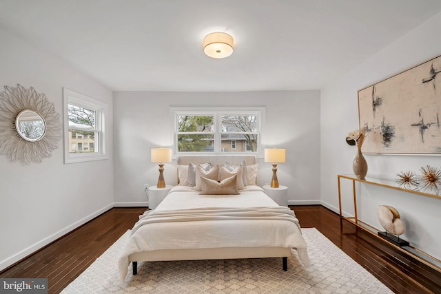 bedroom featuring wood finished floors and baseboards