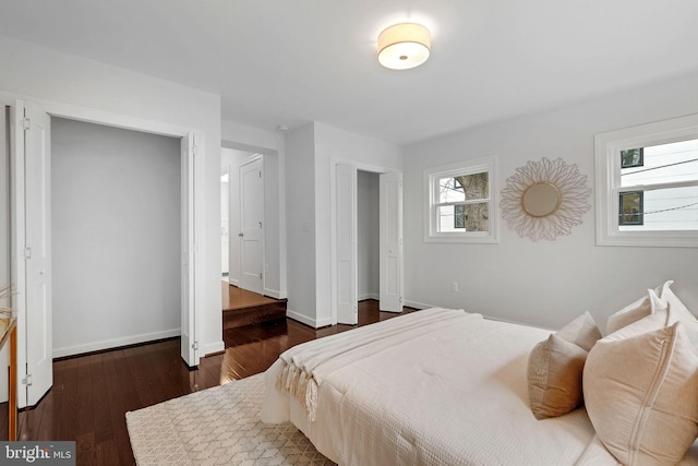 bedroom featuring baseboards and wood finished floors