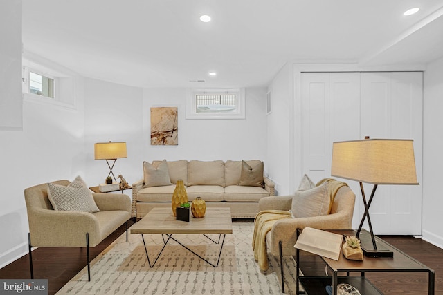 living area featuring recessed lighting, baseboards, and wood finished floors