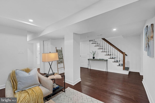 sitting room with stairway, recessed lighting, baseboards, and wood finished floors