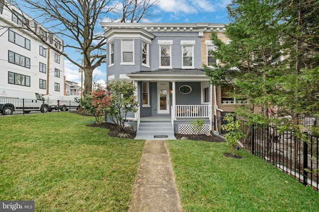 view of front of property featuring brick siding, a porch, a front lawn, and fence