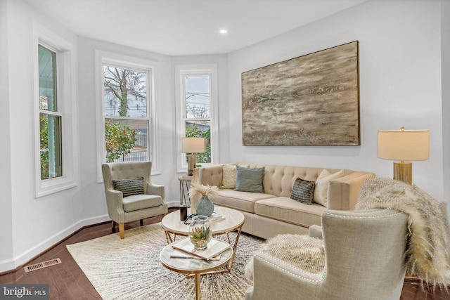 living area with visible vents, recessed lighting, dark wood-type flooring, and baseboards